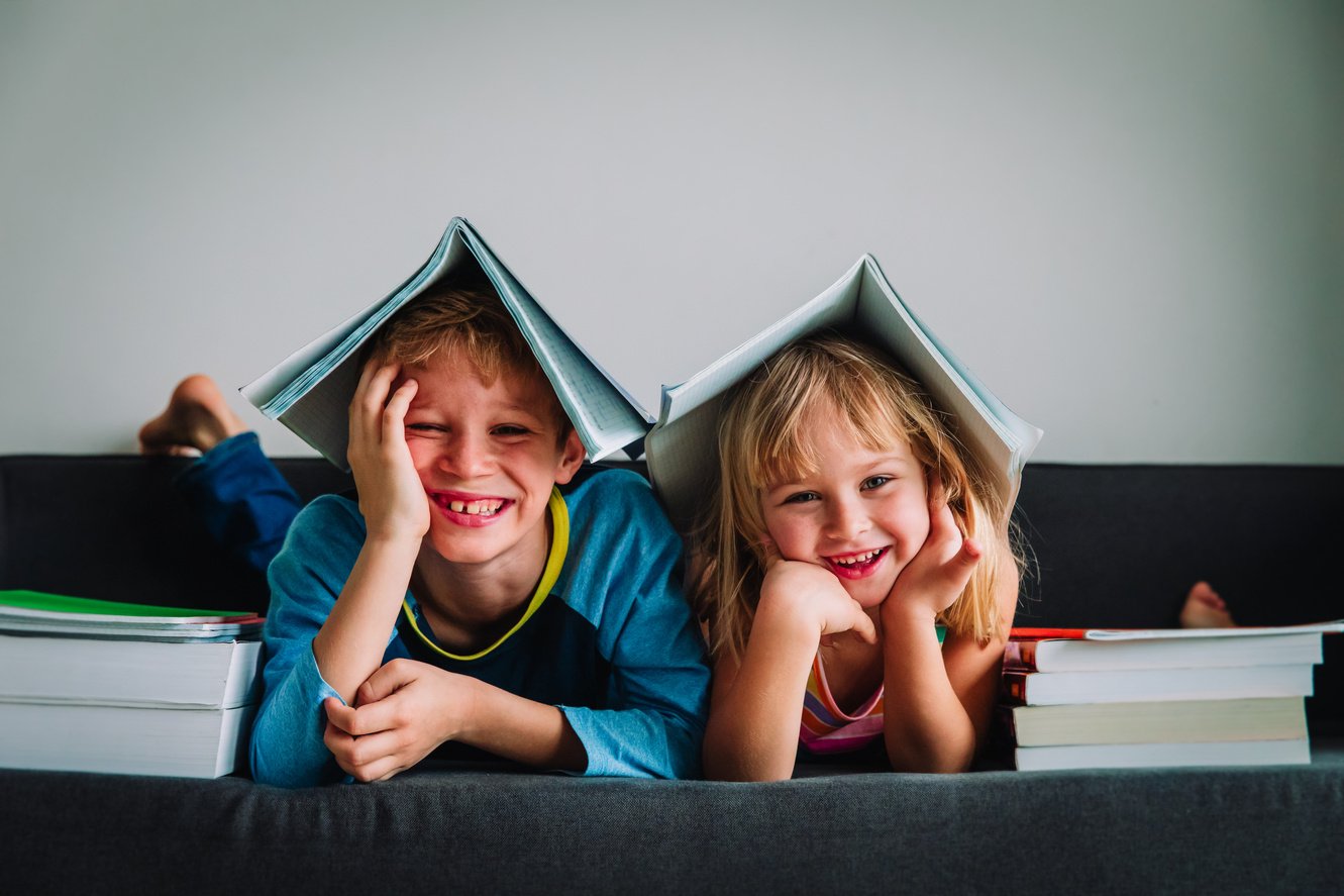 happy boy and girl have fun doing homework