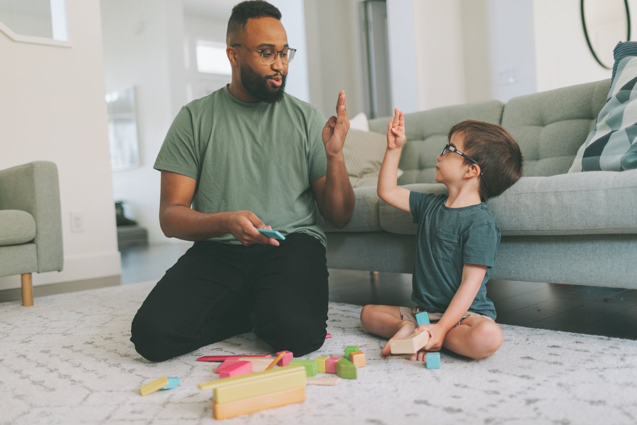 Male Teacher Teaching Boy Alphabets in Sign Language