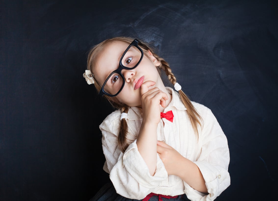 Smart school kid in glasses thinking. Back to school, Kid Creativity and Education Concept