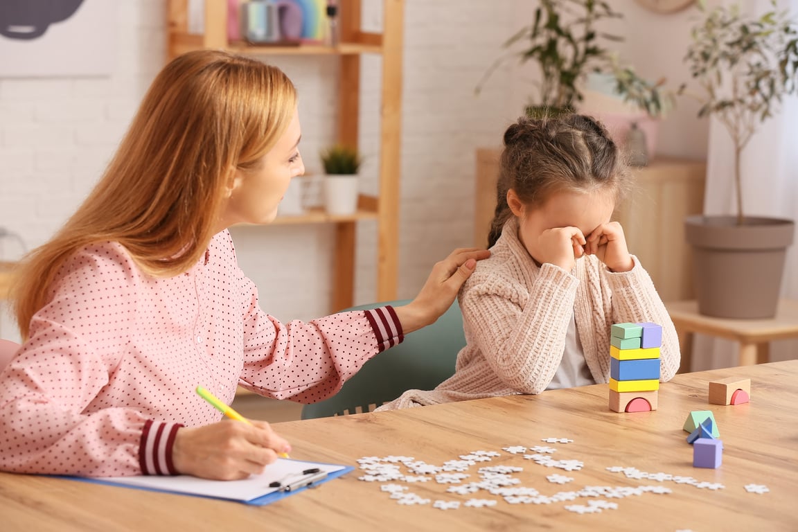 Upset Little Girl with Autistic Disorder at Child Psychologist's Office