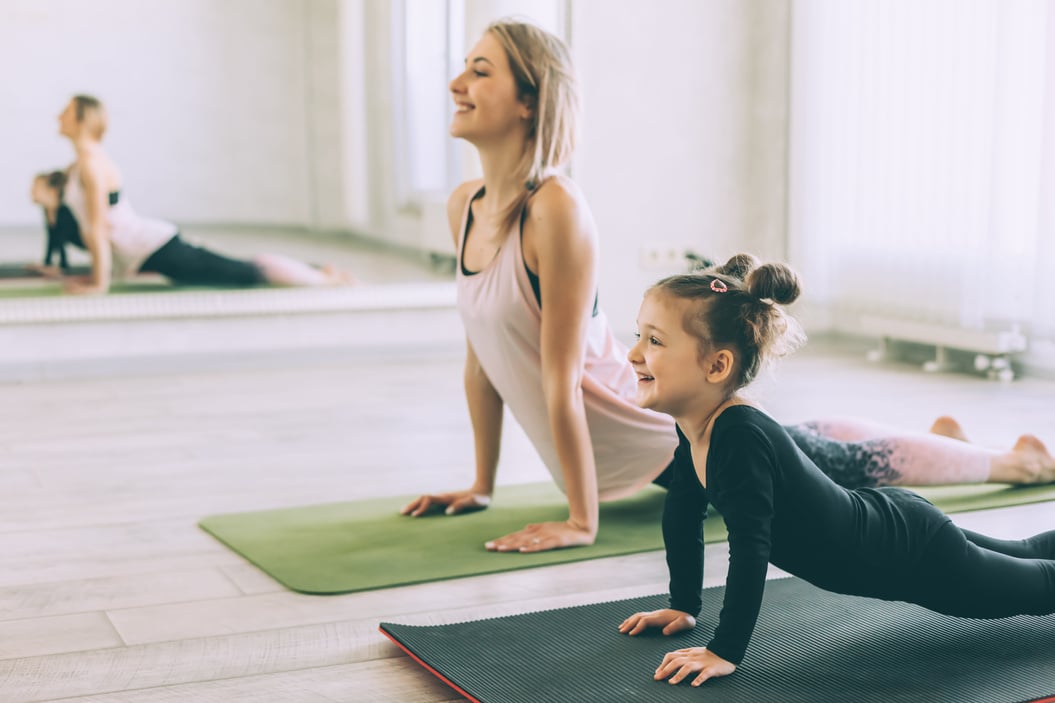 Sporty Woman and Child Girl Doing Stretching Exercise